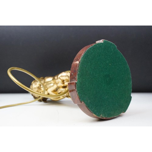 185 - Gilt metal table lamp modelled as two putto, with a red marble base with gilt metal mounts (detached... 