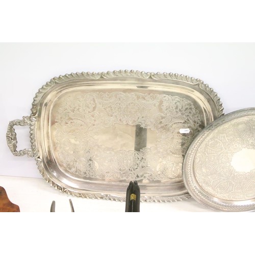 511 - Silver plated twin-handled tray, 61cm long, a silver plated circular tray, two silver plated pepper ... 
