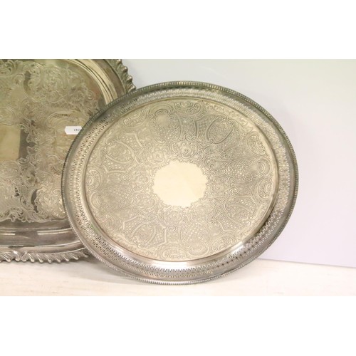 511 - Silver plated twin-handled tray, 61cm long, a silver plated circular tray, two silver plated pepper ... 