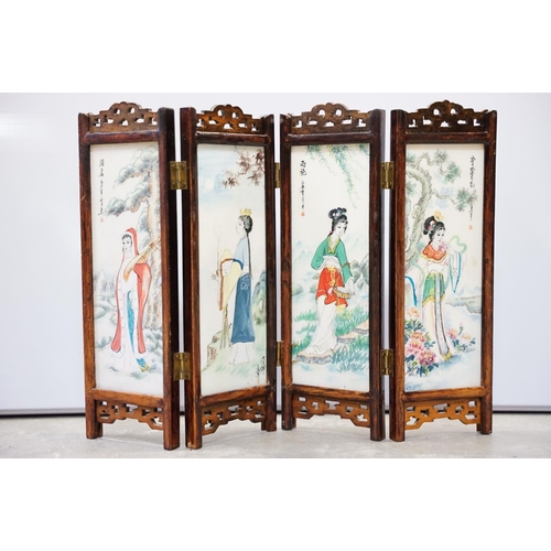 63 - Chinese hardwood table screen, the four panels with double sided painted plaques, 24.5cm high, four ... 