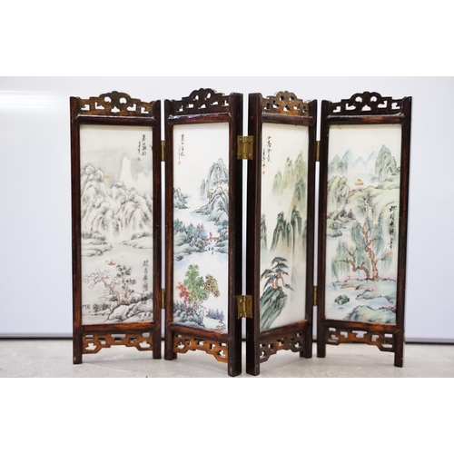 63 - Chinese hardwood table screen, the four panels with double sided painted plaques, 24.5cm high, four ... 