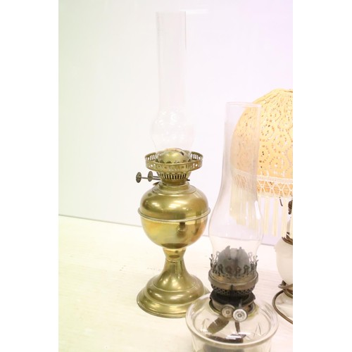 469 - Two 19th Century Victorian oil lamps having milk glass shades together with a carved stone lamp base... 
