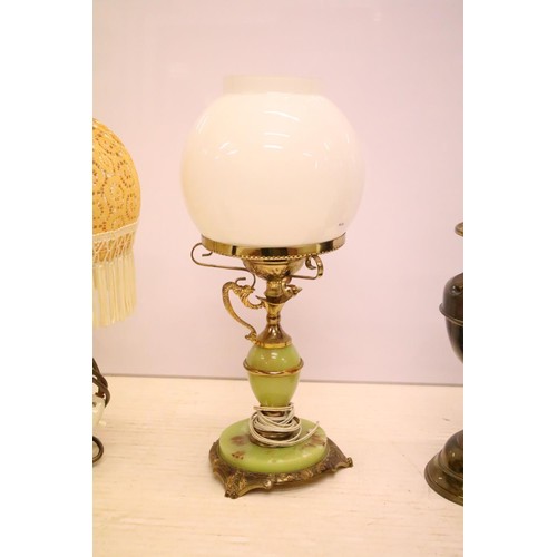 469 - Two 19th Century Victorian oil lamps having milk glass shades together with a carved stone lamp base... 