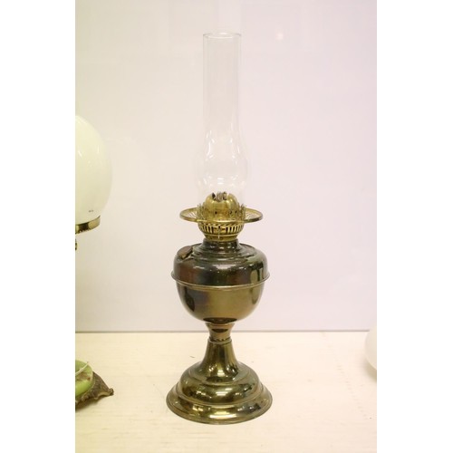 469 - Two 19th Century Victorian oil lamps having milk glass shades together with a carved stone lamp base... 