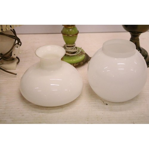 469 - Two 19th Century Victorian oil lamps having milk glass shades together with a carved stone lamp base... 