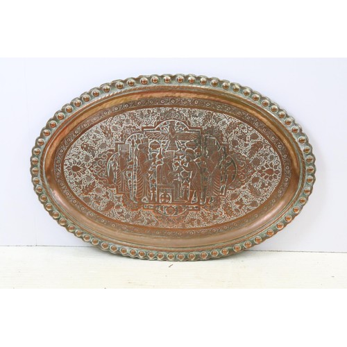 507 - A large copper / silver plated charger with repoussé decoration decoration.