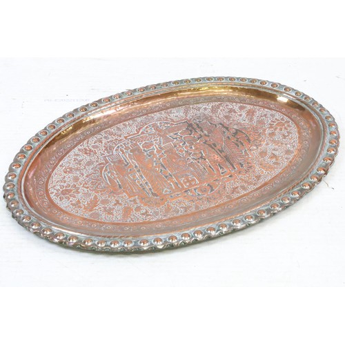507 - A large copper / silver plated charger with repoussé decoration decoration.