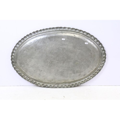 507 - A large copper / silver plated charger with repoussé decoration decoration.