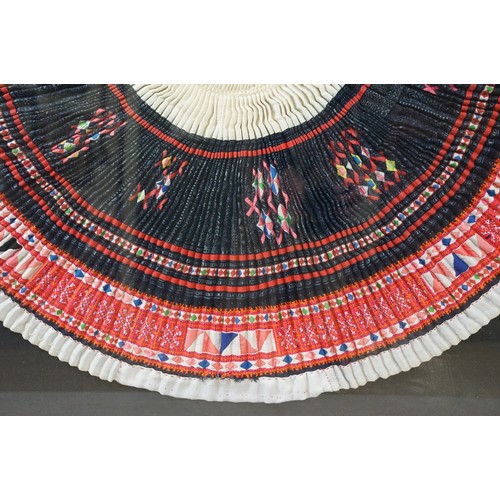 517 - Thai framed hand made tradition Hmong pleated skirt set within a ebonised wooden frame. Measures 127... 