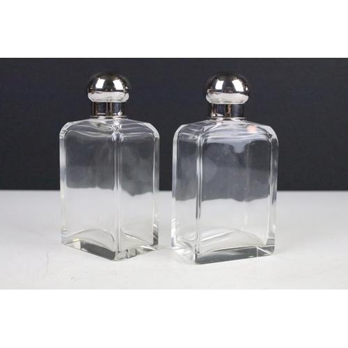 112 - Early 20th century Pair of Glass Bottles and Stoppers with Silver Plate Caps contained within their ... 