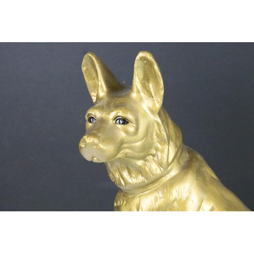 113 - Large chalk painted model of an Alsatian, in gold, climbing green steps, approx 44cm tall