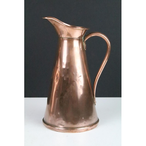 115 - Pair of Art Nouveau copper jugs by Joseph Sankey, 23cm high