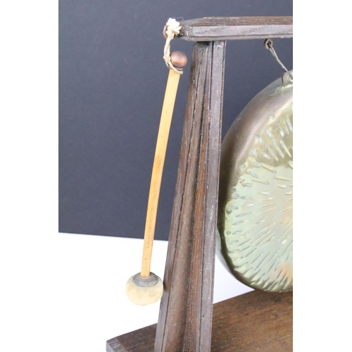 117 - Early 20th century oak and brass dinner gong complete with striker, approx 35cm tall