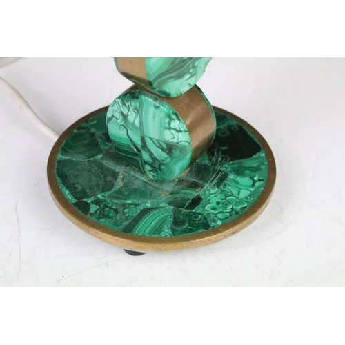 121 - Malachite & brass table lamp raised on a circular base, approx 29cm tall