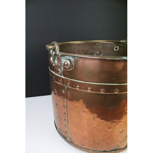 173 - Victorian copper coal bucket of cylindrical form, studded design, with brass loop handle, approx 30c... 