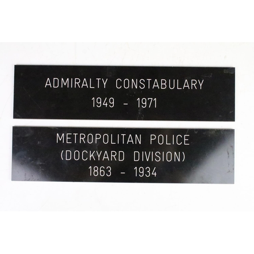 187 - A framed group of Royal New Zealand Police badges together with two police signs.