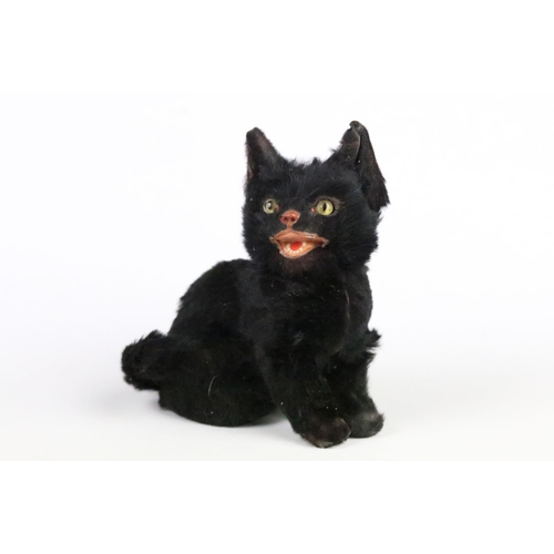 195 - Early 20th century small black fur covered model of a seated cat with open mouth and glass eyes, 8cm... 