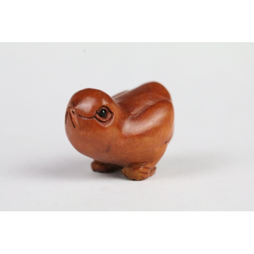 202 - Three Chinese carved wooden animal figurines to include a rabbit, bulldog and chick. Largest measure... 