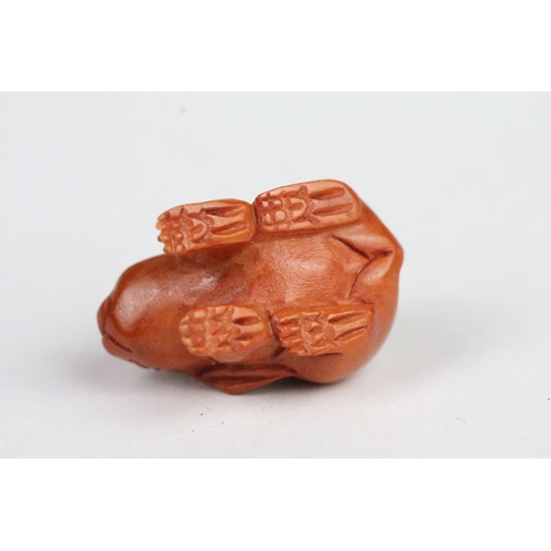 202 - Three Chinese carved wooden animal figurines to include a rabbit, bulldog and chick. Largest measure... 