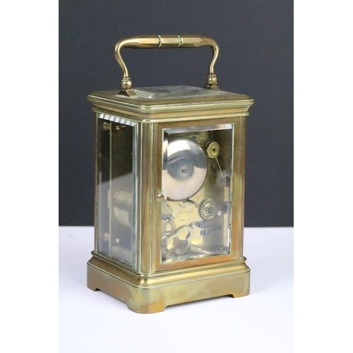 205 - Brass cased carriage clock having bevelled glass to front and sides, roman numerals to chapter ring ... 