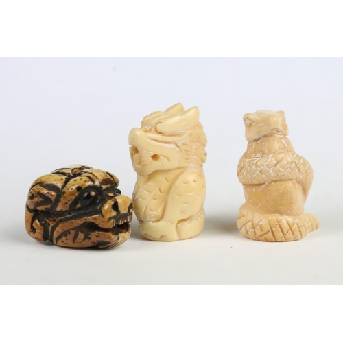 206 - Two Chinese carved resin figurines to include a Chinese dragon and a snake, together with a carved b... 