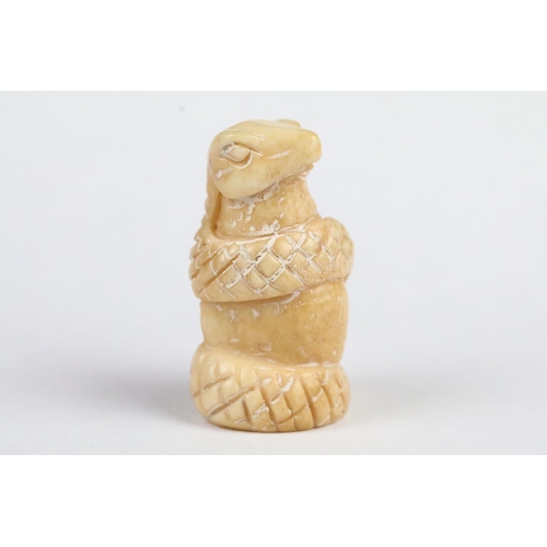 206 - Two Chinese carved resin figurines to include a Chinese dragon and a snake, together with a carved b... 