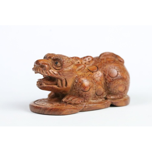 207 - Two Chinese carved figurines to include a fu dog and a fruit. Measures 5.5cm.