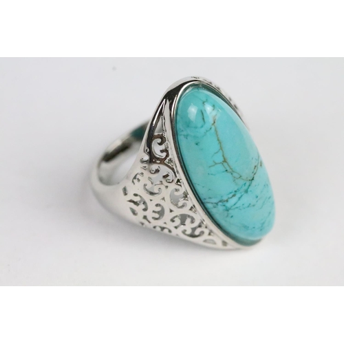 234 - Silver and turquoise dress ring being set with an oval cabochon to centre with pierced shoulders. Ma... 