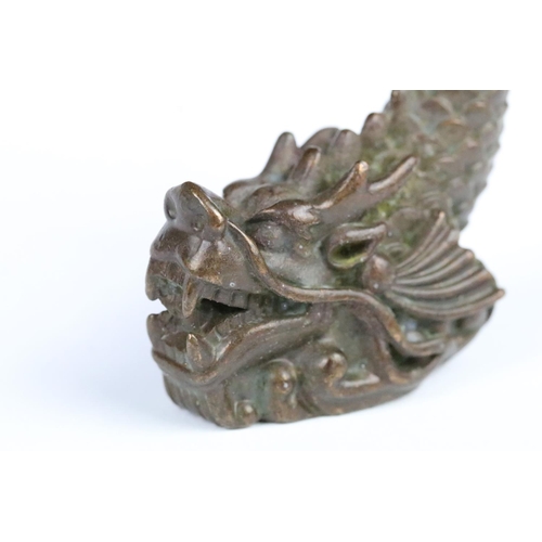 259 - Cast bronze figurine in the form of a Chinese dragon fish. Measures 7cm tall.