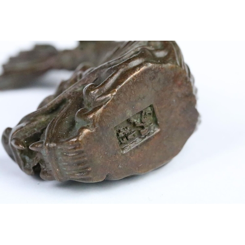 259 - Cast bronze figurine in the form of a Chinese dragon fish. Measures 7cm tall.