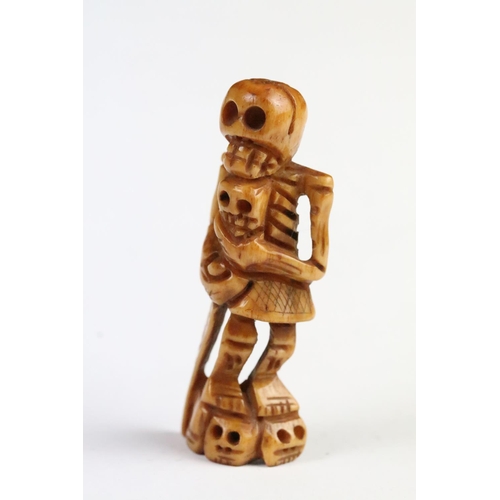 274 - Two carved bone netsuke in the form of skeletons. Measures 6cm and 5.5cm.