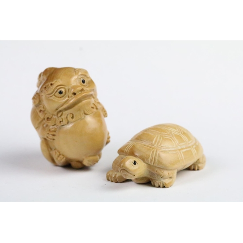 276 - Two carved wooden netsuke in the form of a tortoise and a mythical beast. Measures 5cm and 6.5cm.