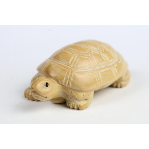 276 - Two carved wooden netsuke in the form of a tortoise and a mythical beast. Measures 5cm and 6.5cm.