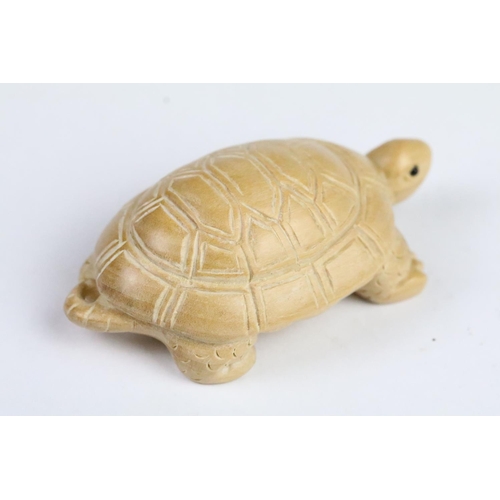 276 - Two carved wooden netsuke in the form of a tortoise and a mythical beast. Measures 5cm and 6.5cm.