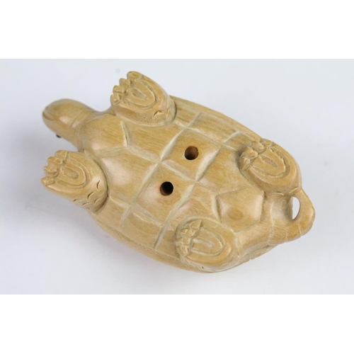 276 - Two carved wooden netsuke in the form of a tortoise and a mythical beast. Measures 5cm and 6.5cm.