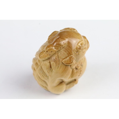 276 - Two carved wooden netsuke in the form of a tortoise and a mythical beast. Measures 5cm and 6.5cm.