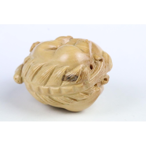 276 - Two carved wooden netsuke in the form of a tortoise and a mythical beast. Measures 5cm and 6.5cm.