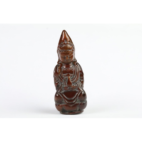 277 - Three carved netsuke toggles to include a laughing Buddha, Guanyin and mask toggle. Largest measures... 