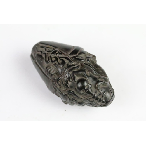 277 - Three carved netsuke toggles to include a laughing Buddha, Guanyin and mask toggle. Largest measures... 