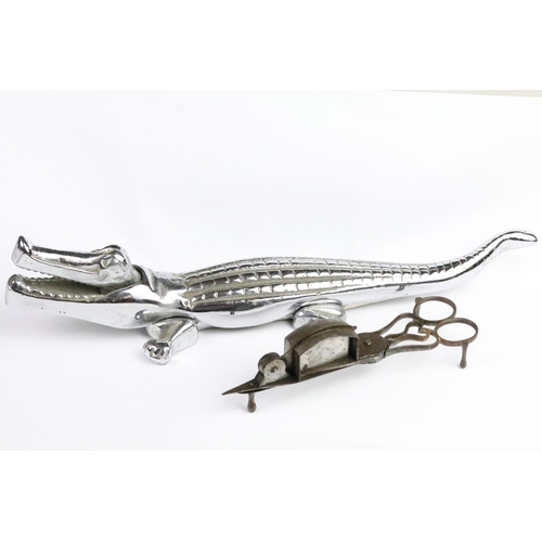 281 - Pair of Victorian candle snuffers with wick trimming action together with a cast metal alligator nut... 