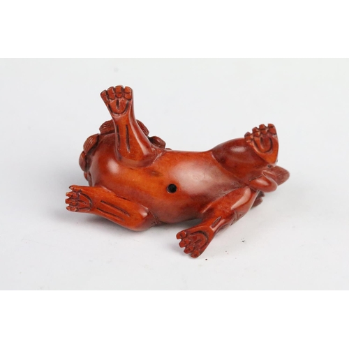 283 - Two carved wooden netsuke to include a pig and a fu dog. Measures 5cm and 6cm.