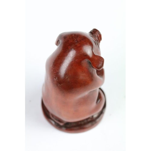 283 - Two carved wooden netsuke to include a pig and a fu dog. Measures 5cm and 6cm.