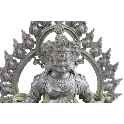 286 - Cast bronze Hindu deity figure raised on a lotus base. Measures 11cm.