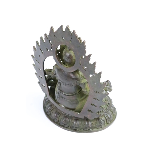 286 - Cast bronze Hindu deity figure raised on a lotus base. Measures 11cm.