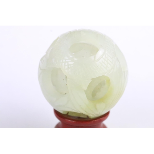 287 - Jade Puzzle Ball carved with a fish design comprising three layers plus a central ball, 6cm wide, on... 