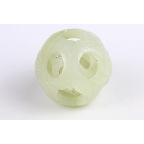 287 - Jade Puzzle Ball carved with a fish design comprising three layers plus a central ball, 6cm wide, on... 