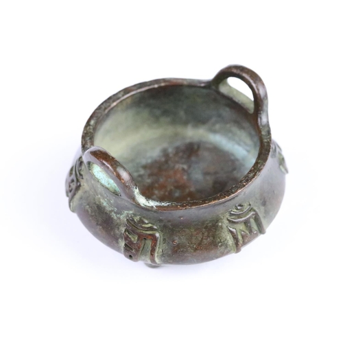 293 - Cast bronze censer with wing handles and three moulded feet. Measures 5.5cm wide.