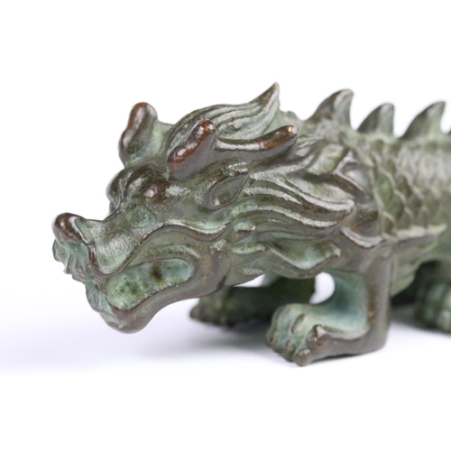 300 - Cast bronze figurine in the form of a Chinese dragon. Measures 8cm wide.