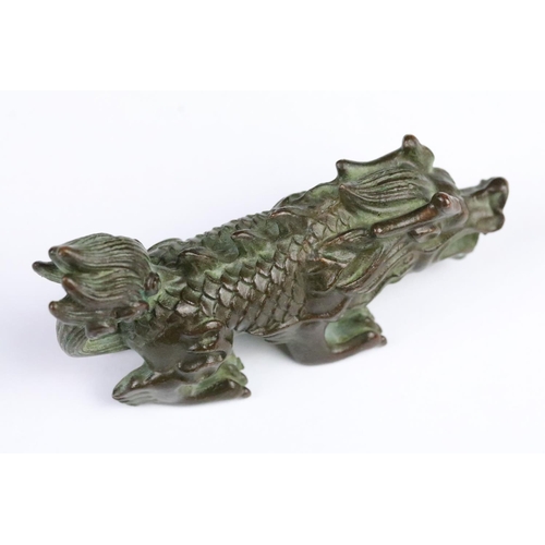 300 - Cast bronze figurine in the form of a Chinese dragon. Measures 8cm wide.