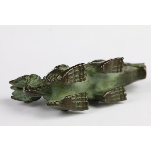 300 - Cast bronze figurine in the form of a Chinese dragon. Measures 8cm wide.